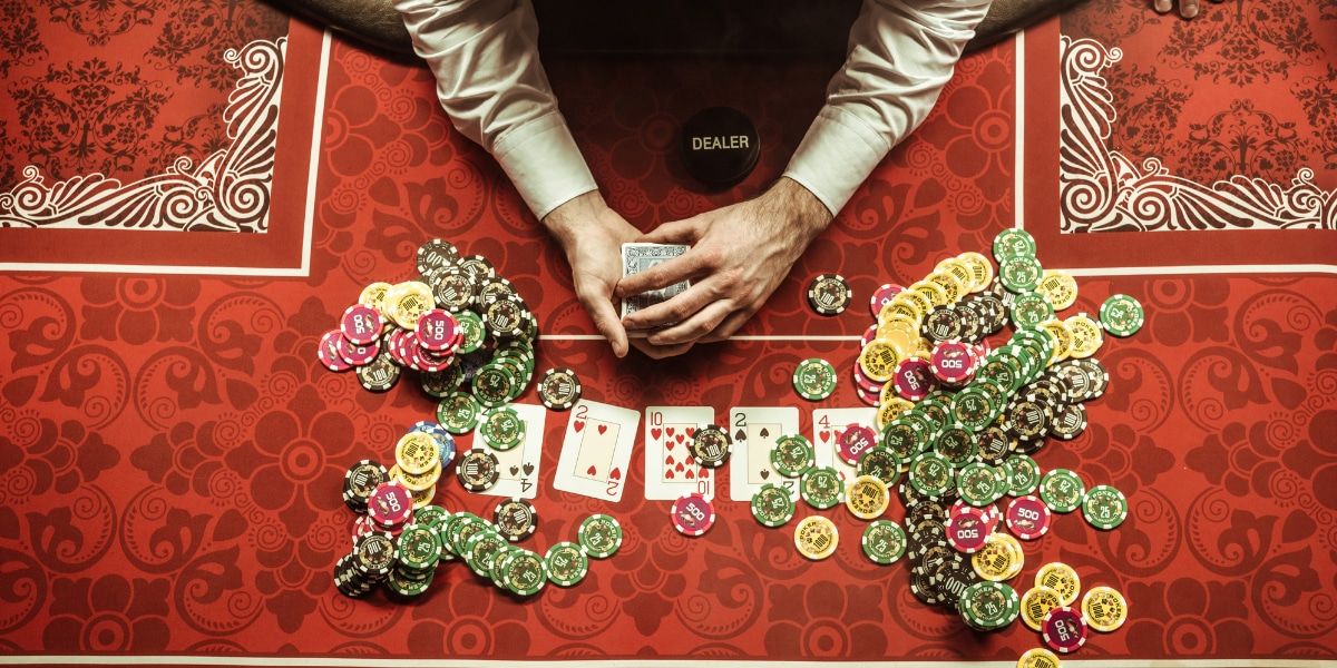casino dealer during his shift, aerial view, sorting cards and chips at his casino table to prepare the next game
