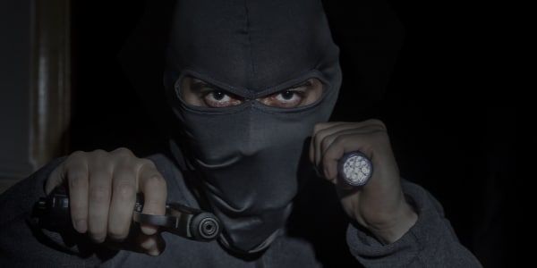 masked criminal during robbery at night